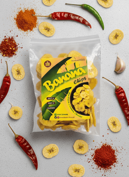 Packaged spicy banana chips with brand logo on a light background with scattered chili peppers.